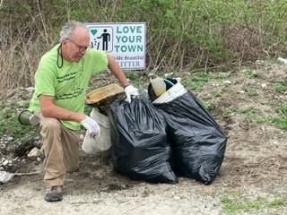 Man cleaning litter in Burrillville