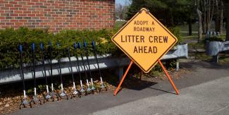 Clean up gear near a sign that says "Litter Crew Ahead"